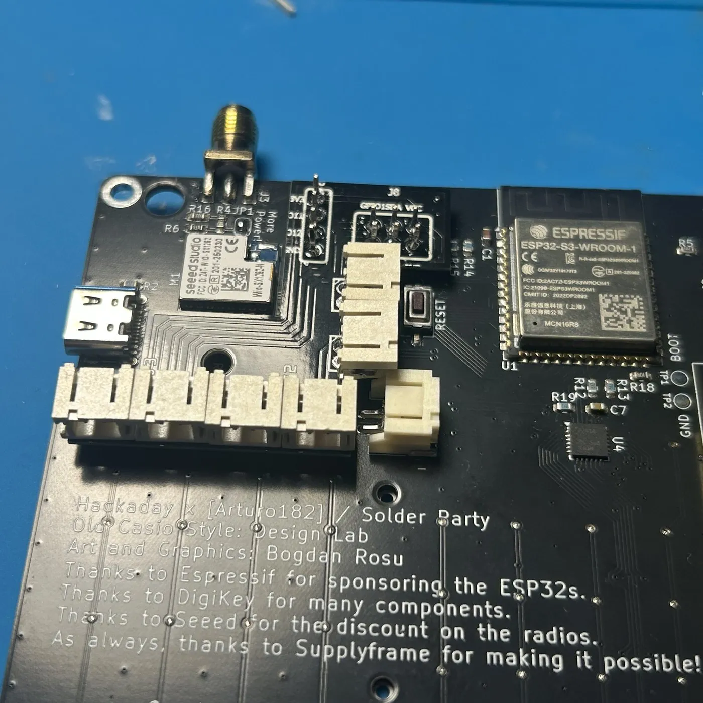 The same board from a low angle, showing the six sockets in a row and the clearance to the reset button.